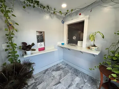 a room with a window and shelves with plants at Economy Inn - Burbank Airport in Sun Valley
