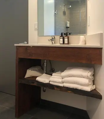 a bathroom with a sink and a pile of towels at The M Malibu in Malibu