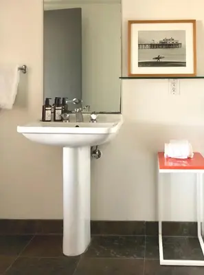 a bathroom with a sink and a mirror at The M Malibu in Malibu