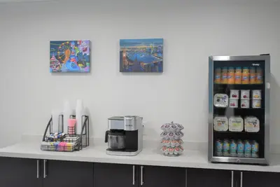 a counter top with a coffee maker and drinks at Signature Anaheim Maingate in Anaheim