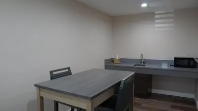 a kitchen with a wooden table and a sink at Sea Breeze Inn - LAX Airport, Los Angeles in Inglewood