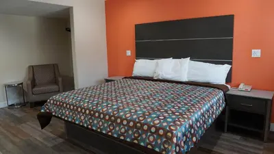 a hotel room with a bed and a chair at Sea Breeze Inn - LAX Airport, Los Angeles in Inglewood
