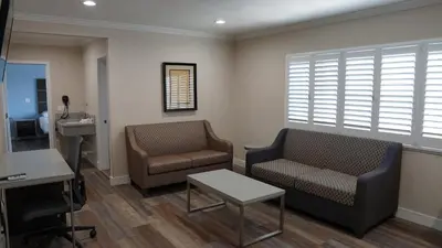 a waiting room with two chairs and a table at Sea Breeze Inn - LAX Airport, Los Angeles in Inglewood