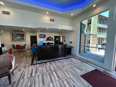 a lobby with a waiting area and a large window at Motel 6 Pasadena, CA Old Town Pasadena Area in Pasadena