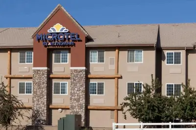 a hotel with a sign on the front of it at Microtel Inn & Suites by Wyndham Wheeler Ridge in Wheeler Ridge