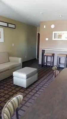 a living room with a couch and a table at Microtel Inn & Suites by Wyndham Wheeler Ridge in Wheeler Ridge