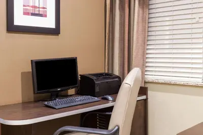 a desk with a computer and a printer on it at Microtel Inn & Suites by Wyndham Wheeler Ridge in Wheeler Ridge