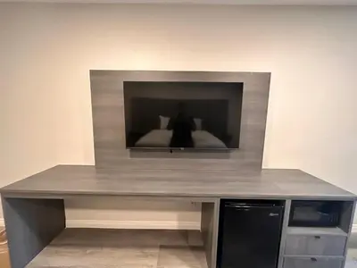 a desk with a television on top of it at Five Star Inn in West Covina