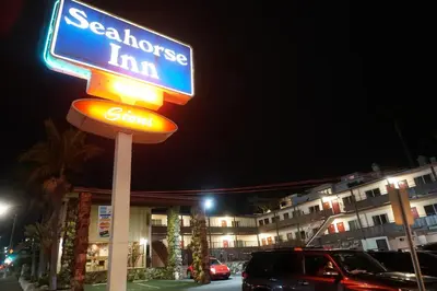 a sign for a seahorse inn at night at Seahorse Inn Manhattan Beach - LAX in Manhattan Beach