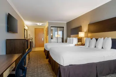 a hotel room with two beds and a flat screen tv at Best Western Los Angeles Worldport Hotel in Wilmington