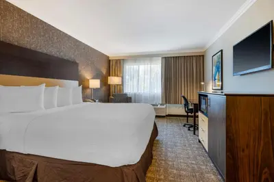 a hotel room with a large bed and a flat screen tv at Best Western Los Angeles Worldport Hotel in Wilmington