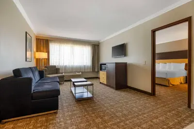 a hotel room with a couch and a bed at Best Western Los Angeles Worldport Hotel in Wilmington