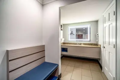 a bathroom with a sink and a mirror at Travelodge Inn & Suites by Wyndham Bell Los Angeles Area in Bell