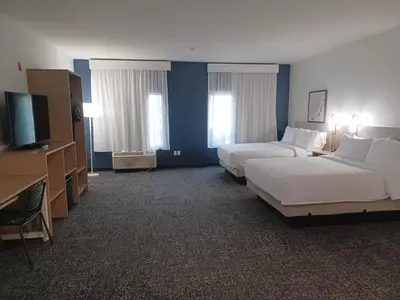 a hotel room with two beds and a flat screen tv at Spark By Hilton Redlands in Redlands