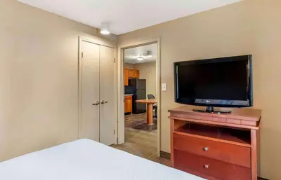 a bedroom with a flat screen tv on a dresser at Extended Stay America Suites - Bakersfield - Chester Lane in Bakersfield