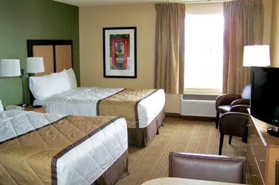 a hotel room with two beds and a television at Extended Stay America Suites - Bakersfield - Chester Lane in Bakersfield