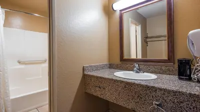 a bathroom with a sink and a mirror at Empire Inn in San Bernardino