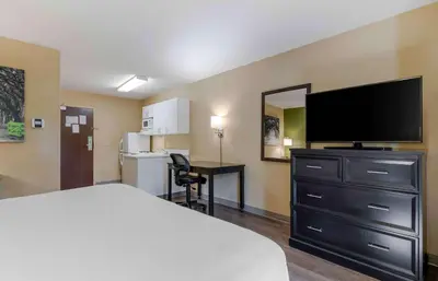 a hotel room with a bed and a flat screen tv at Extended Stay America Suites - Los Angeles - Glendale in Glendale