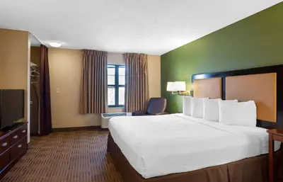 a hotel room with a large bed and a television at Extended Stay America Suites - Los Angeles - Glendale in Glendale