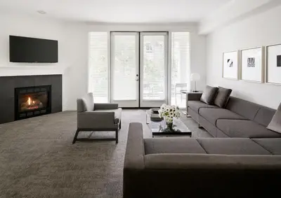 a living room with a couch and a fireplace at AKA Beverly Hills in Los Angeles