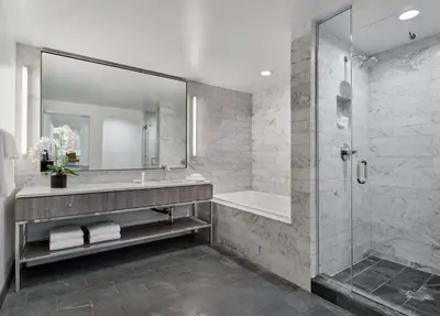 a bathroom with a tub and a sink and a shower at AKA Beverly Hills in Los Angeles