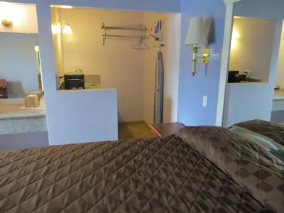 a bedroom with a bed and a mirror at Park Cienega Motel in Los Angeles