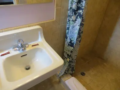 a bathroom with a sink and a shower at Park Cienega Motel in Los Angeles