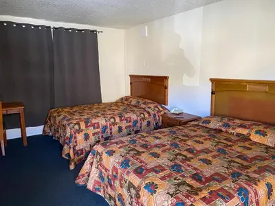 a hotel room with two beds and a window at Golden Hills Motel in Tehachapi