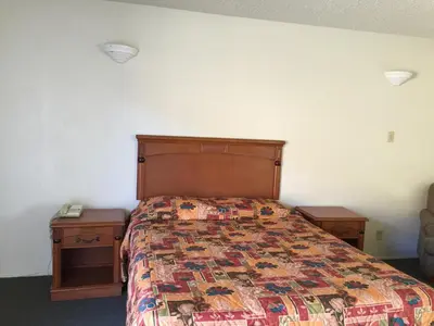 a bedroom with a bed and two night stands at Golden Hills Motel in Tehachapi
