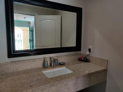 a bathroom sink with a large mirror above it at LYFE INN & SUITES by AGA - LAX Airport in Inglewood