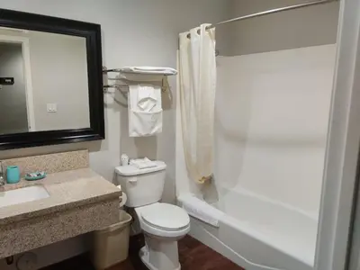 a bathroom with a toilet and a sink and a shower at LYFE INN & SUITES by AGA - LAX Airport in Inglewood