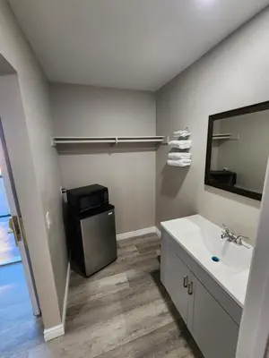a bathroom with a sink and a large mirror at Star Inn On Route 66, Barstow in Barstow