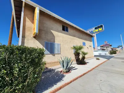 a building with plants in front of it at Star Inn On Route 66, Barstow in Barstow