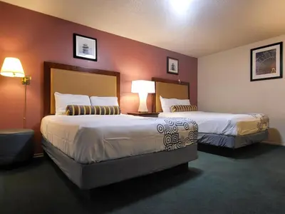 a hotel room with two beds and two lamps at Star Inn On Route 66, Barstow in Barstow