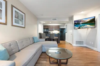 a living room with a couch and a table at Chase Suites Brea-Fullerton - North Orange County in Brea