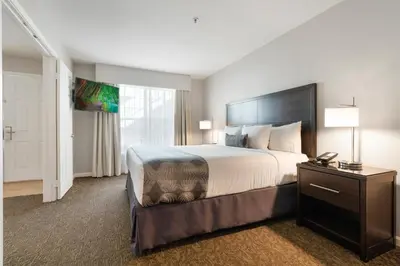 a hotel room with a large bed and a window at Chase Suites Brea-Fullerton - North Orange County in Brea