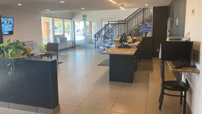 a restaurant with a counter and stairs in a room at Quality Inn & Suites near Downtown Bakersfield in Bakersfield