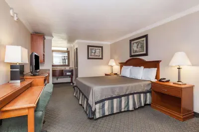 a hotel room with a bed and a television at Travelodge by Wyndham Sylmar CA in Sylmar