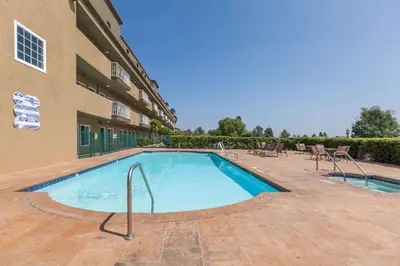 a swimming pool in front of a building at Travelodge by Wyndham Sylmar CA in Sylmar