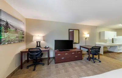 a hotel room with a desk with a television and chairs at Extended Stay America Suites - Los Angeles - Simi Valley in Santa Susana Knolls