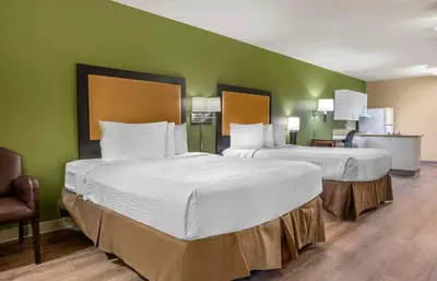 two beds in a hotel room with green walls at Extended Stay America Suites - Los Angeles - Simi Valley in Santa Susana Knolls