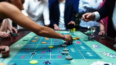 a group of people playing a board game on a table at Kings Motel Inglewood in Inglewood