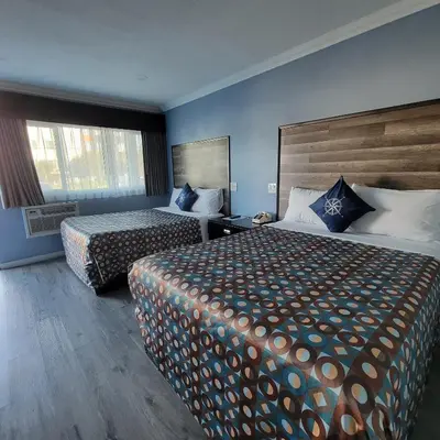 a hotel room with two beds and a window at Guest Harbor Inn- Port Of Los Angeles San Pedro in San Pedro