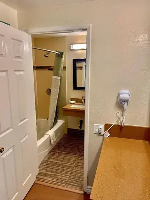 a bathroom with a tub and a sink and a shower at Relax Inn in Los Angeles