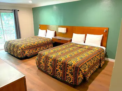 a hotel room with two beds in a room at Relax Inn in Los Angeles