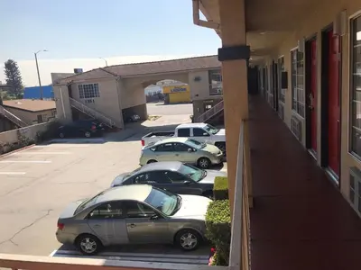 a group of cars parked in a parking lot at Economy Inn LAX Inglewood in Inglewood