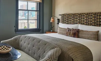 a bedroom with a large bed and a window at Downtown Los Angeles Proper Hotel, a Member of Design Hotels in Los Angeles