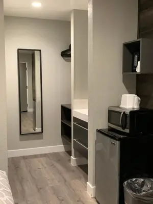 a bathroom with a microwave and a mirror at Sakura Inn in Glendale