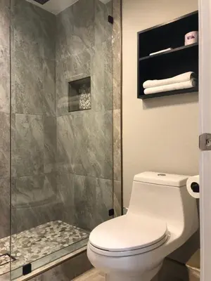 a bathroom with a toilet and a shower at Sakura Inn in Glendale