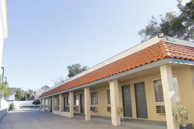 an old building with a red roof at Royal Inn in Lomita